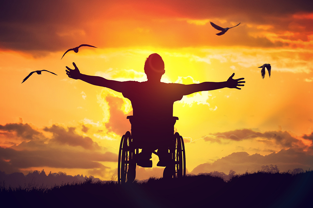 Person ina wheelchair at sunset