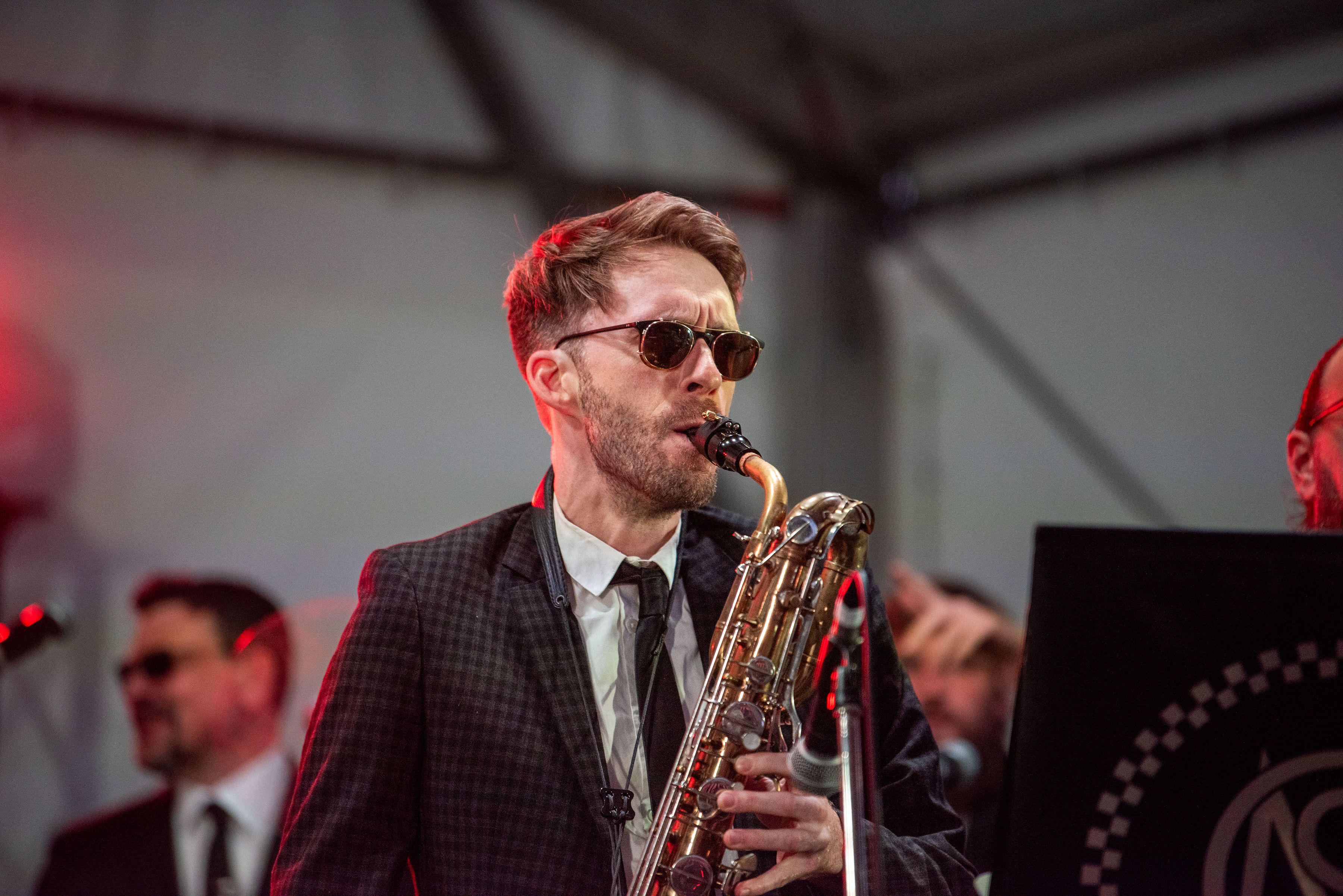 Man in suit playing the saxophone