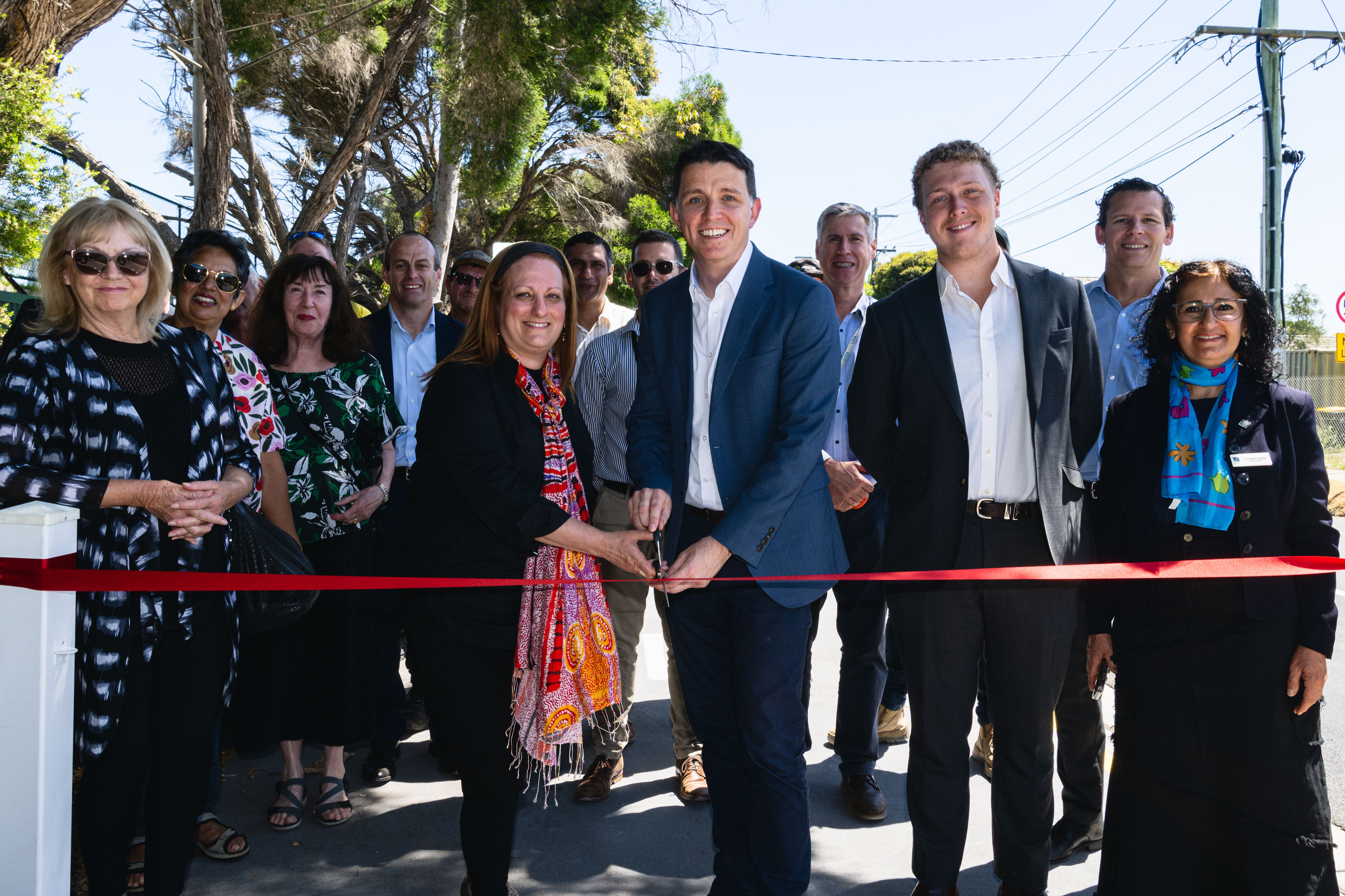 Cr Margarett Esakoff, Mayor Simone Zmood, Ryan Batchelor MLC, Deputy Mayor Luca Ragni and Cr Arabella Daniels who are joined by Council staff, local community members and Robert Bradshaw and Chris Yue from the Level Crossing Removal Project.